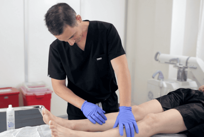 dr-with-patient Vein Specialist in NYC
